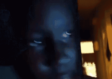 a blurry picture of a person 's face with a lamp in the background