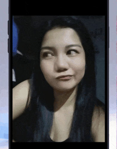 a woman 's face is displayed on a cell phone screen