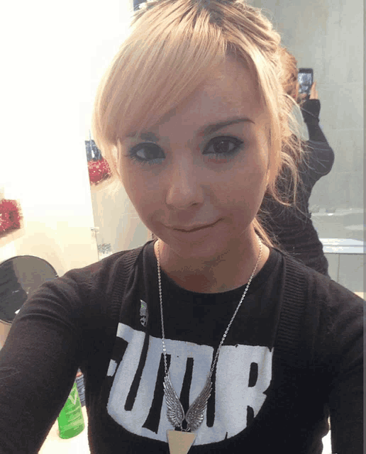 a woman taking a selfie with a shirt that says jump on it