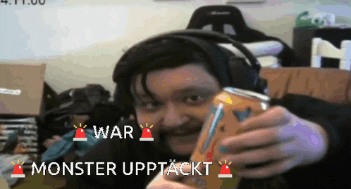 a man wearing headphones is holding a can of soda with the words war and monster upptackt written below him