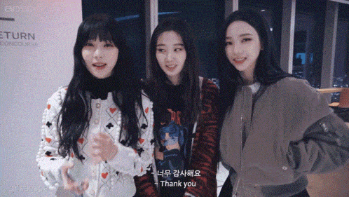 three girls are posing for a picture and one of them is saying thank you