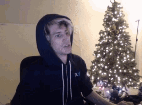 a man wearing a hoodie with the letter t on it