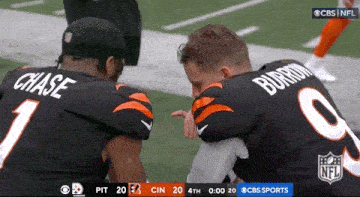 two nfl players chase and burrom are kneeling down on the field