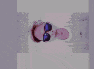a person wearing sunglasses and a shirt that says exiled co