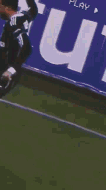 a soccer player wearing a jersey that says harika is kicking a ball