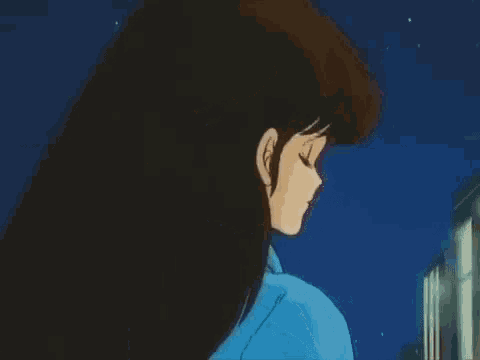 a girl with long brown hair and blue eyes is wearing a blue jacket