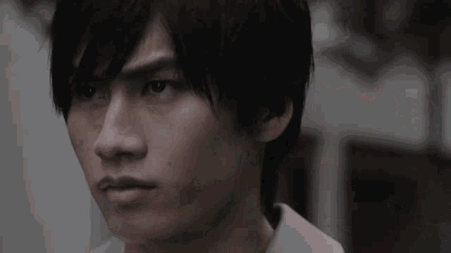 a close up of a man 's face with a serious look on his face