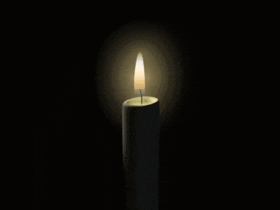 a white candle with a picture of a man on it