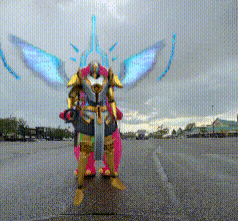 a person in a costume with wings and a sword standing in a parking lot