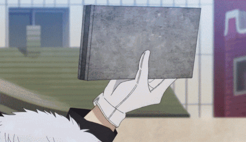 a person wearing white gloves is holding a brick
