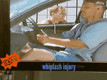 a man is driving a car with a whiplash injury on the screen