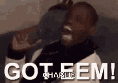 a man is sitting on a couch with his mouth open and the words `` got fem charlie '' written on the screen .