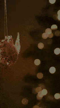 a blurred image of a christmas tree with a pink and yellow border