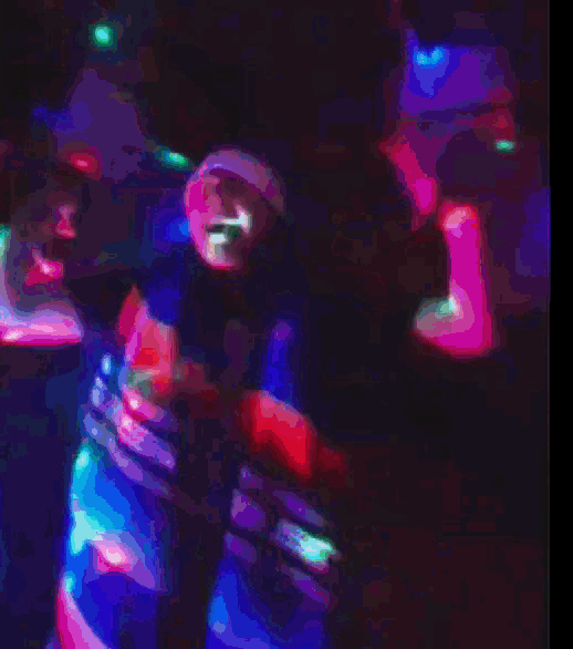 a blurry picture of a man dancing in a dark room