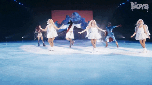 a group of women ice skating on a stage with the word boys in the background