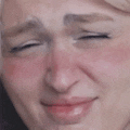 a close up of a person 's face with their eyes closed and a red cheek .