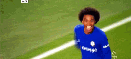 two soccer players are standing on a field and one of them is wearing a blue shirt with the name hazard on it .