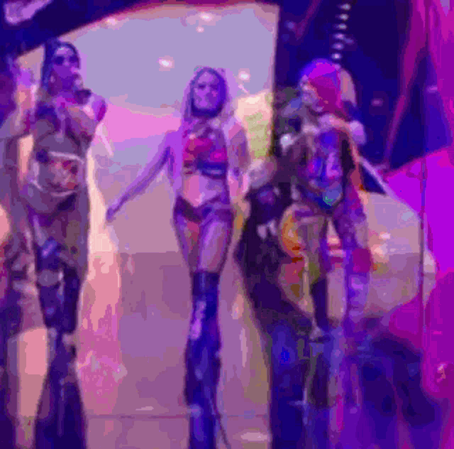 a group of women are standing on stilts in a dark room .