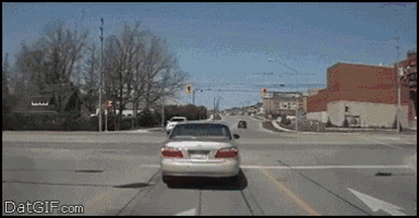 a gif of a car driving down a street with the words datgif.com at the top