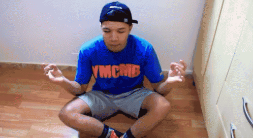 a man wearing a blue shirt that says ymcmb
