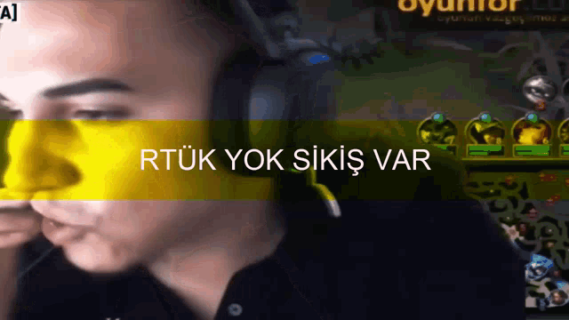 a man wearing headphones with the words rtuk yok sikiş var on the bottom right