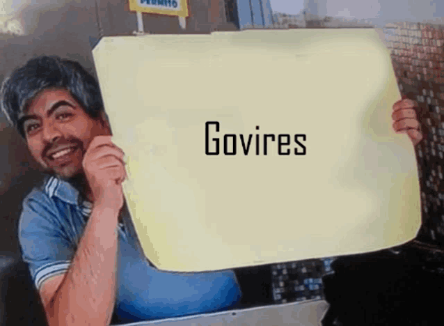 a man is holding a sign that says govires