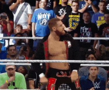 a man in a wrestling ring is wearing a shirt that says not p1