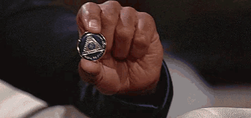 a close up of a person holding a coin