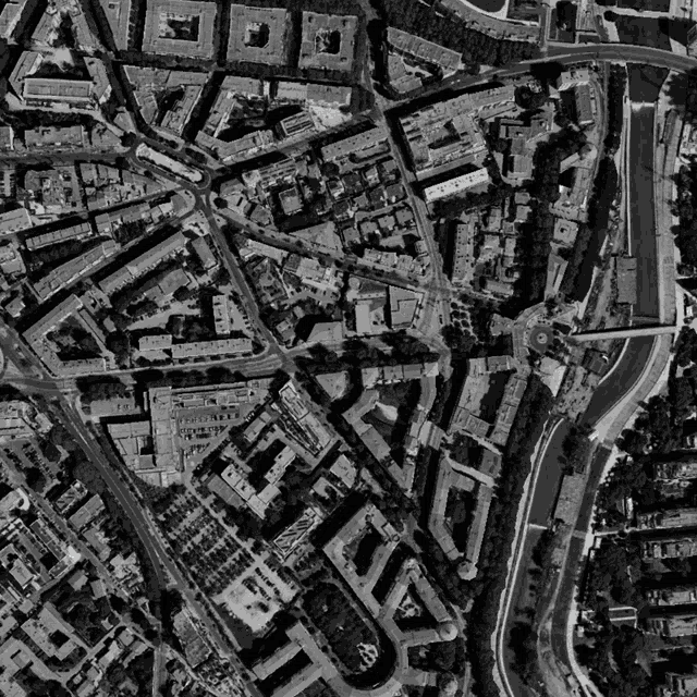 a black and white aerial view of a city with a river