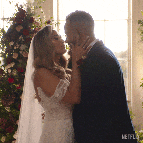 a bride and groom kissing in front of a window with netflix written on the bottom