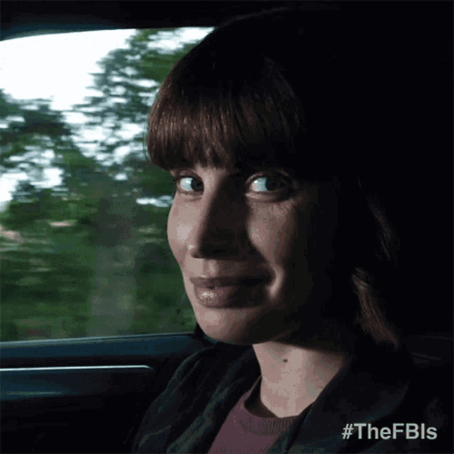a woman sitting in a car with the hashtag #thefbls on her face