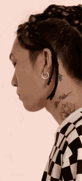 a close up of a person 's neck with a tattoo on it