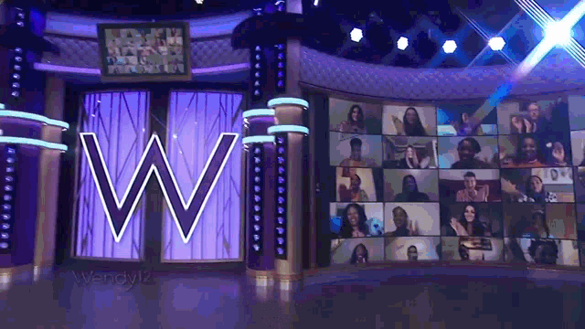 a group of people are gathered in front of a large w