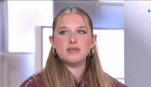 a close up of a woman 's face with a green screen behind her that says ' rtl ' on it