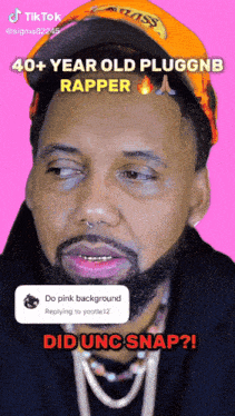 a man with a beard is wearing an orange hat and a black hoodie