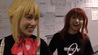 two girls are standing next to each other and one has a shirt that says ' live ' on it