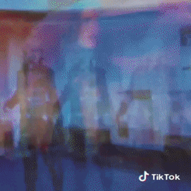 a blurred image of a tv screen with a tiktok logo in the corner