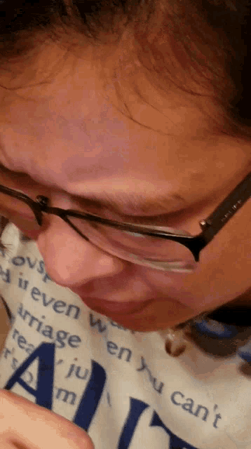 a person wearing glasses and a shirt that says " you can 't " on it