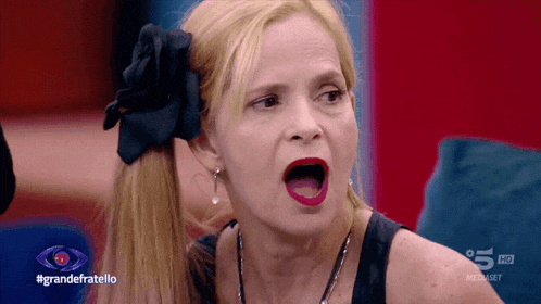 a woman with a black flower in her hair is on a television show called grande fratello