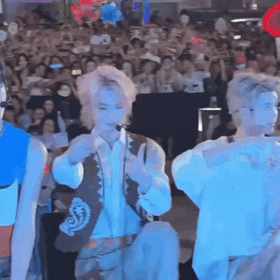 a group of people are standing in front of a crowd .