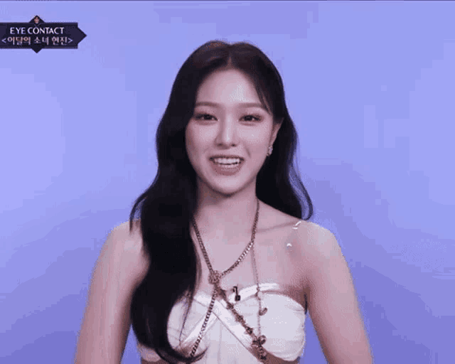a woman is wearing a strapless dress and a necklace with the words eye contact on the bottom