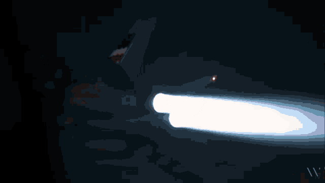 a red light shines in the dark with the letters wv visible