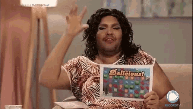 a woman is holding a piece of paper that says " delicious "