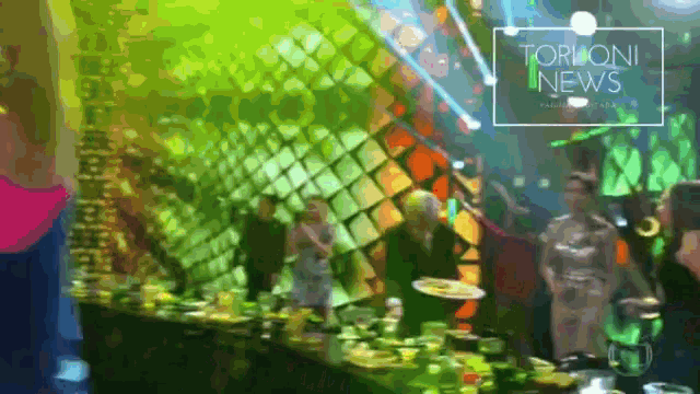 a blurred image of a party with the words torloni news on the bottom