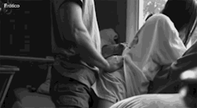 a black and white photo of a man and a woman having sex