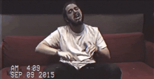 a man in a white shirt is sitting on a red couch with the date sep 09 2015