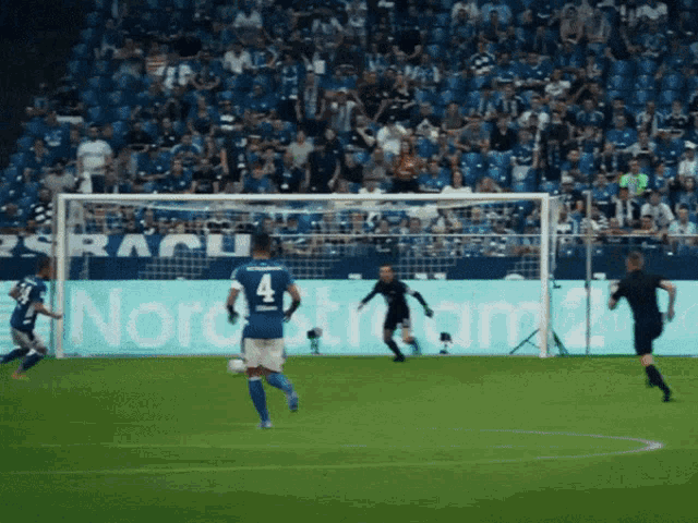 soccer players on a field with a sign that says nordstrom in the background