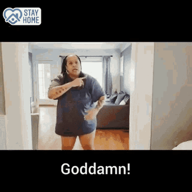 a woman in a blue shirt is standing in a living room with the words goddamn below her