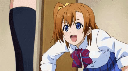 a girl with brown hair and blue eyes is wearing a white shirt and blue plaid skirt