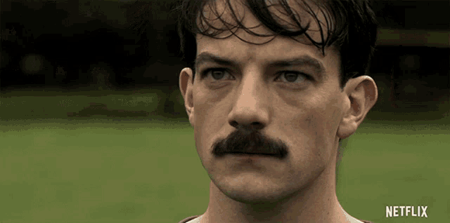 a close up of a man with a mustache and the word netflix on the bottom